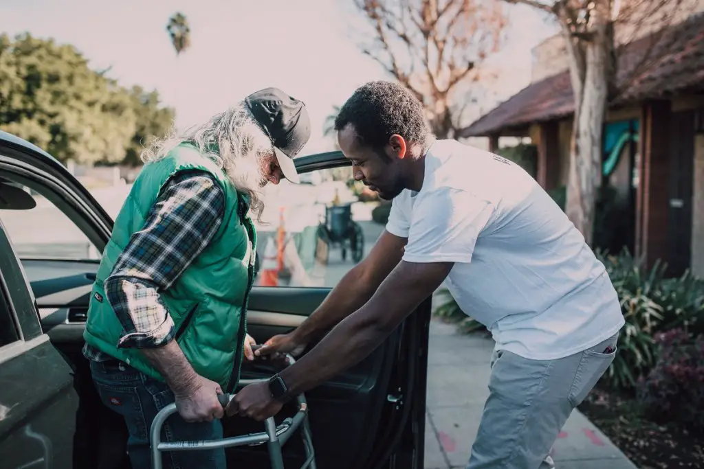 man helping elderly woman