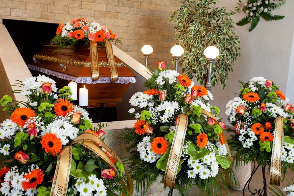 Orange and white funeral arrangement