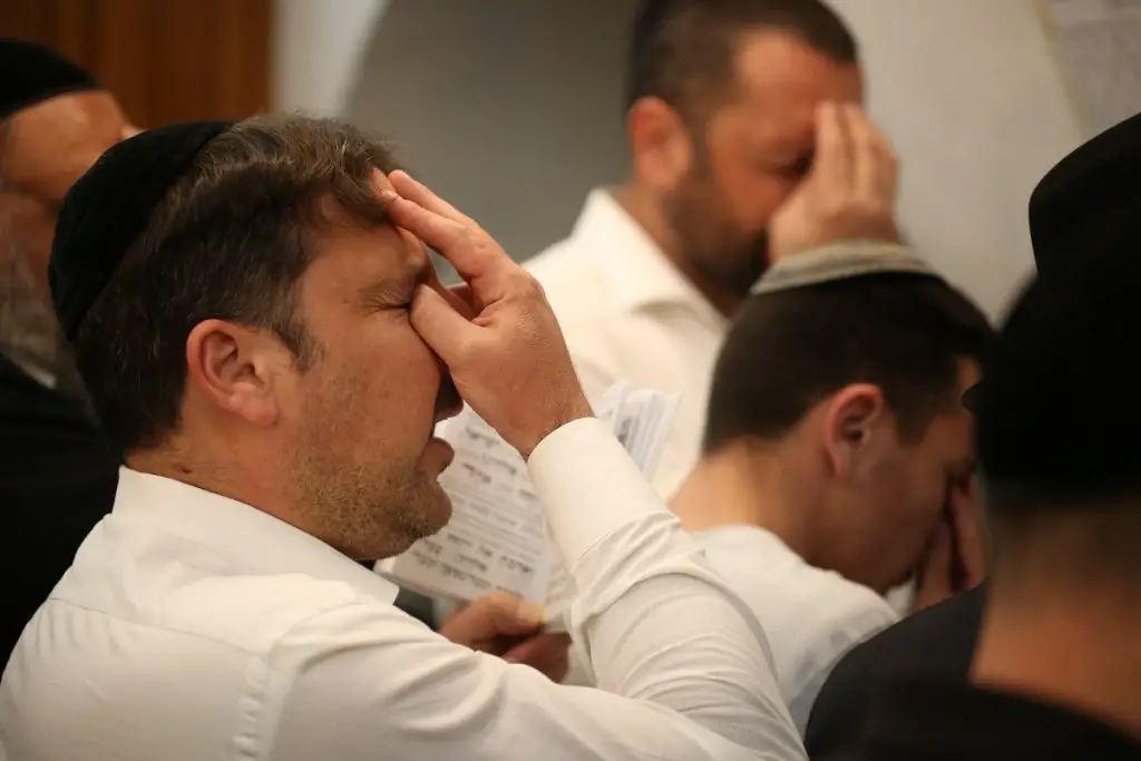 Men pray at home during shiva