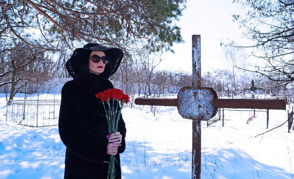 Woman at winter funeral