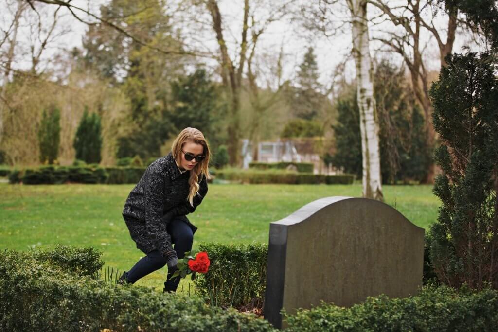 Placing flower on the grave