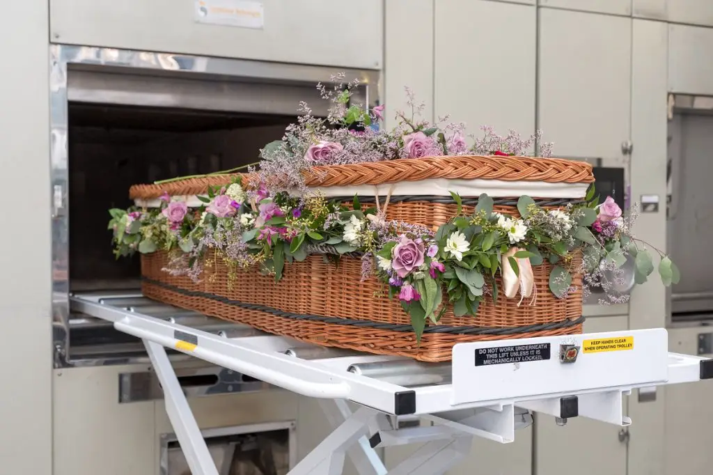 Cremation casket going into furnace